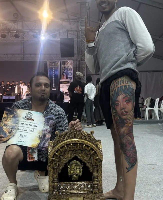 Ravi at a tattoo convention with the winning artist and trophy
